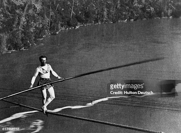 Charles Blondin, the French acrobat, performs a tightrope walk high above the Niagara River.