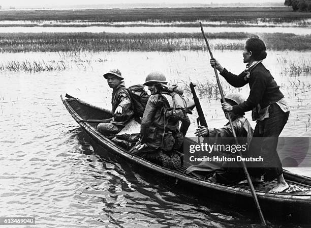 Members of a combi action company, comprising US marines and platoons of the Vietnamese popular forces, employ the help of a local to cross a river...