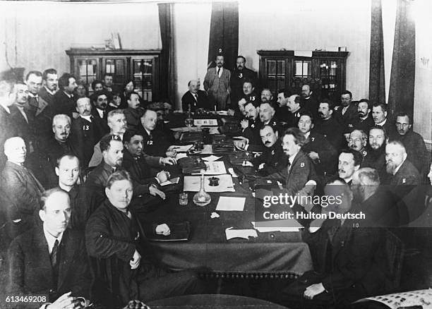 Lenin presides over a meeting of the Bolshevik Council of People's Commissars, or Sovnarkom, attended by Leon Trotsky.