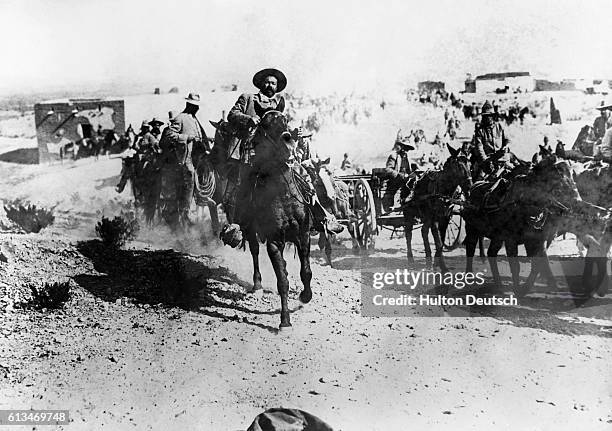 Pancho Villa leads other Mexican rebels on horseback.