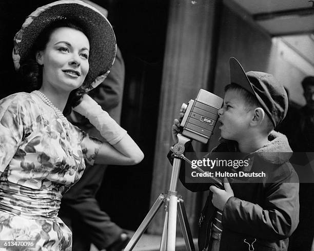 Six year old Robert Rodgers takes a picture of the film star Anne Heywood as she arrives at the Savoy Hotel, 1958.