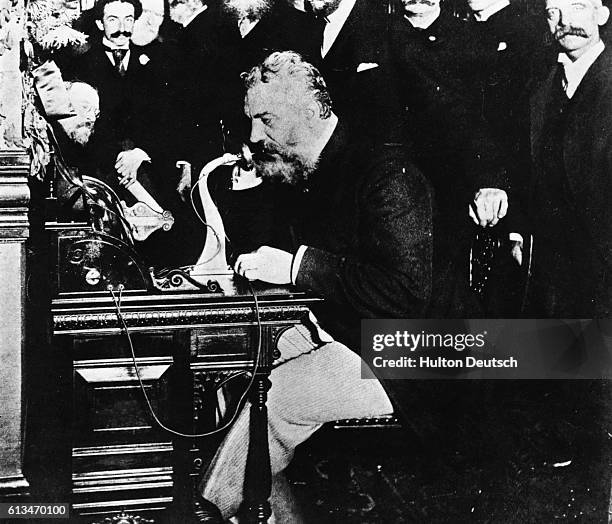 In the centennial year of 1876, Alexander Graham Bell sent his first telephone message. Here he is 16 years later, surrounded by executives, making...