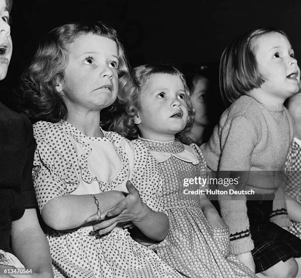 Sisters, Francine and Wendy Paine, are among an audience of awestruck children at a performance of Dick Wittington put on by employees of the...