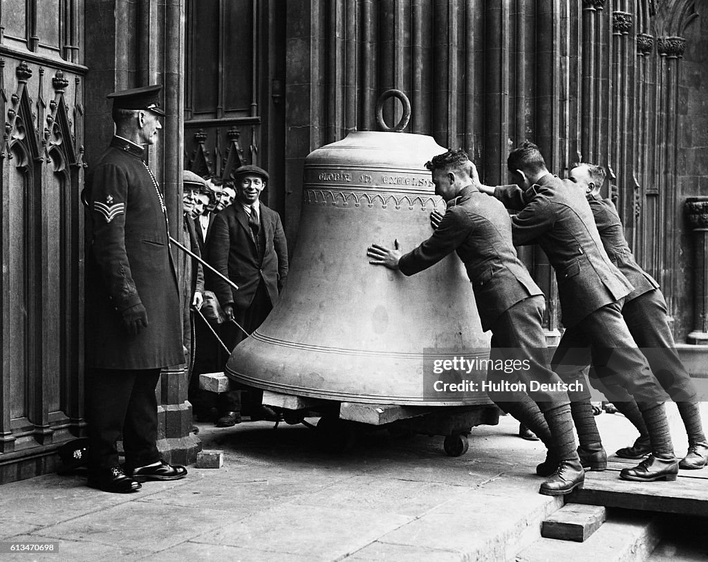 Men Push A Cathedral Bell