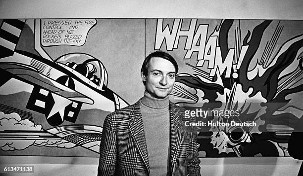 Pop Art painter Roy Lichtenstein in front of his painting Whaam! during an exhibition of his work at the Tate Gallery, London.