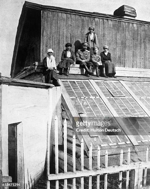 The Romanov family sit on a roof in Tobolsk.