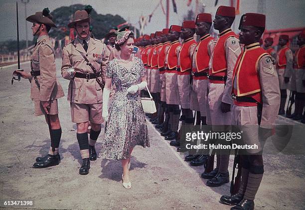 Queen Elizabeth II inspects men of the newly-renamed Queen's Own Nigeria Regiment, Royal West African Frontier Force, at Kaduna Airport, Nigeria,...
