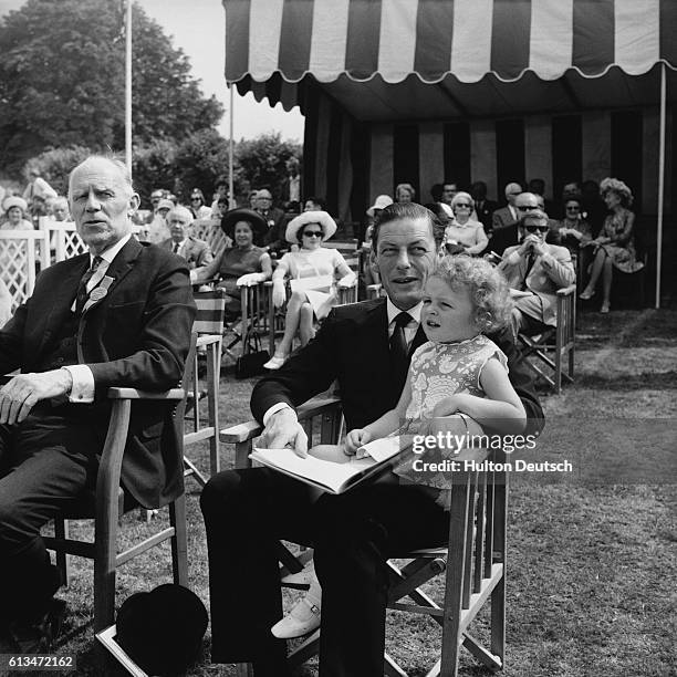 Angus Ogilvy, husband of Princess Alexandra, with their four year old daughter Marina on his knee at the 1970 Metropolitan Police Horse Show.