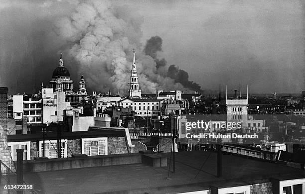 Smoke pours from a building near St. Paul's Cathedral during the Blitz bombing campaign in London. September 1940.