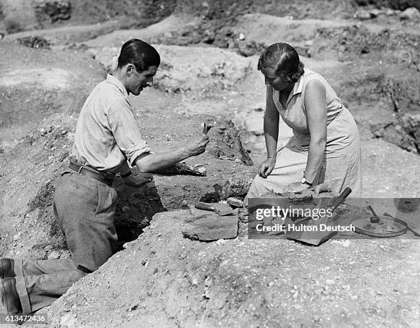 Archaeologists Kathleen Kenyon and C.N. Goodman examining pieces of Roman pottery discovered on the site. A nearly complete Roman theatre has been...