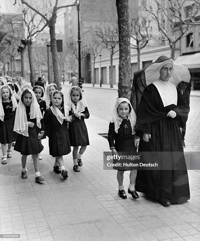 Nun Leads Children to School