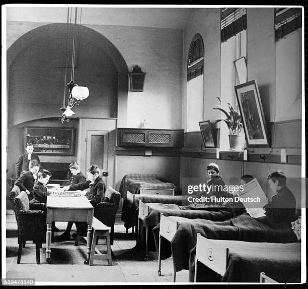 Students of Christ's Hospital boarding school relax by reading and playing chess in their dormitory.