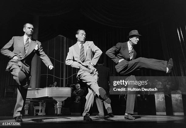 Three acclaimed actors Laurence Olivier, John Mills and John Gielgud take part in a charity performance at the London Palladium in a sketch where...