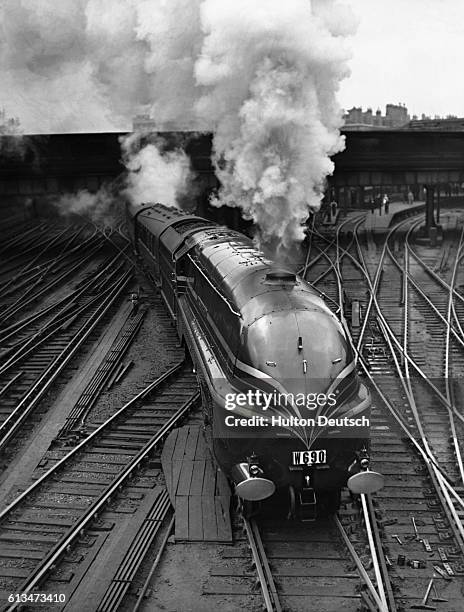 The stylish, streamlined steam locomotive known as the Duchess of Gloucester departs from Euston Station, London, pulling a train carrying 120...