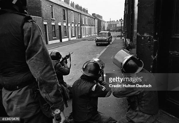 British Army soldiers attempt to dispel rioters during unrest in the Falls Road. Belfast, 1970.