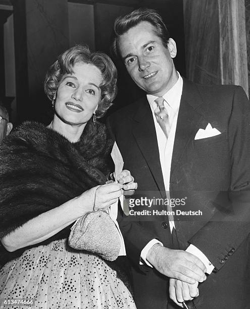 Actor Denholm Elliot and actress Constance Cummings arriving at the Royal Opera House for the last night of Antigone, London, 1959.