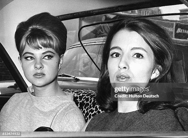 Christine Keeler and Mandy Rice Davies leave the Old Bailey after the first day of the Ward Trail concerning the Profumo scandal.