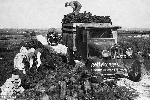 The lorry that is now used to bring in the peat from this Connemara bog replaced the traditional horse and cart. | Location: Connemara Bog, Ireland.