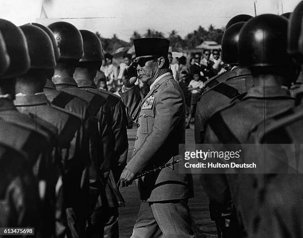 President Sukarno, the first leader of Indonesia after it became a republic in 1945, inspects his troops.