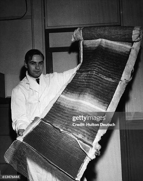 An assistant at the Fuel Research station's Air Pollution Section shows a filter taken from an air conditioning plant in London after one nights use....