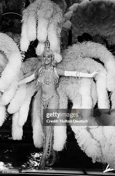 Scantily clad showgirl on stage during the Paris theater's spectacular centenary performance.