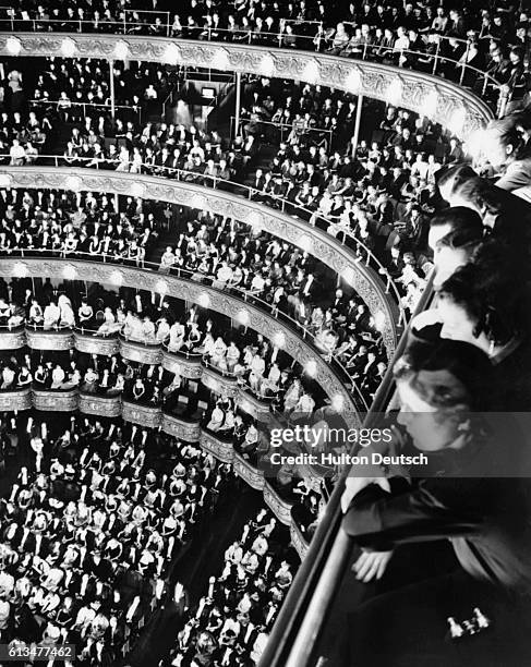 Crowd watches a performance of Verdi's Othello on opening night at the Metropolitan Opera House in New York.