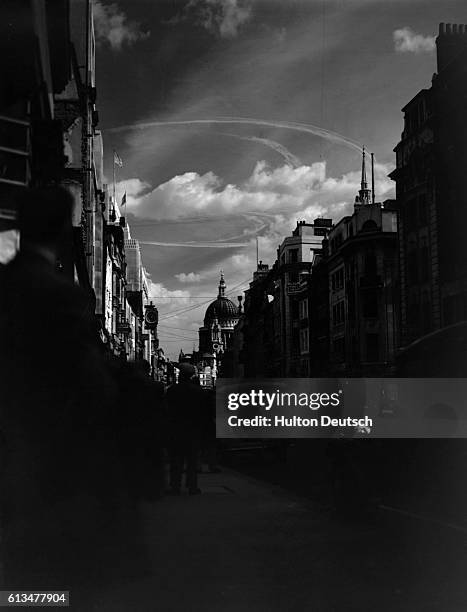 Dogfight leaves white rings of vapour in the sky above the dome of St. Paul's Cathedral. London, 1940.