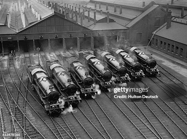 Three King locomotives , fresh from the assembly plant, stand among a lineup of seven express engines at a Great Western Railway yard. One of the...