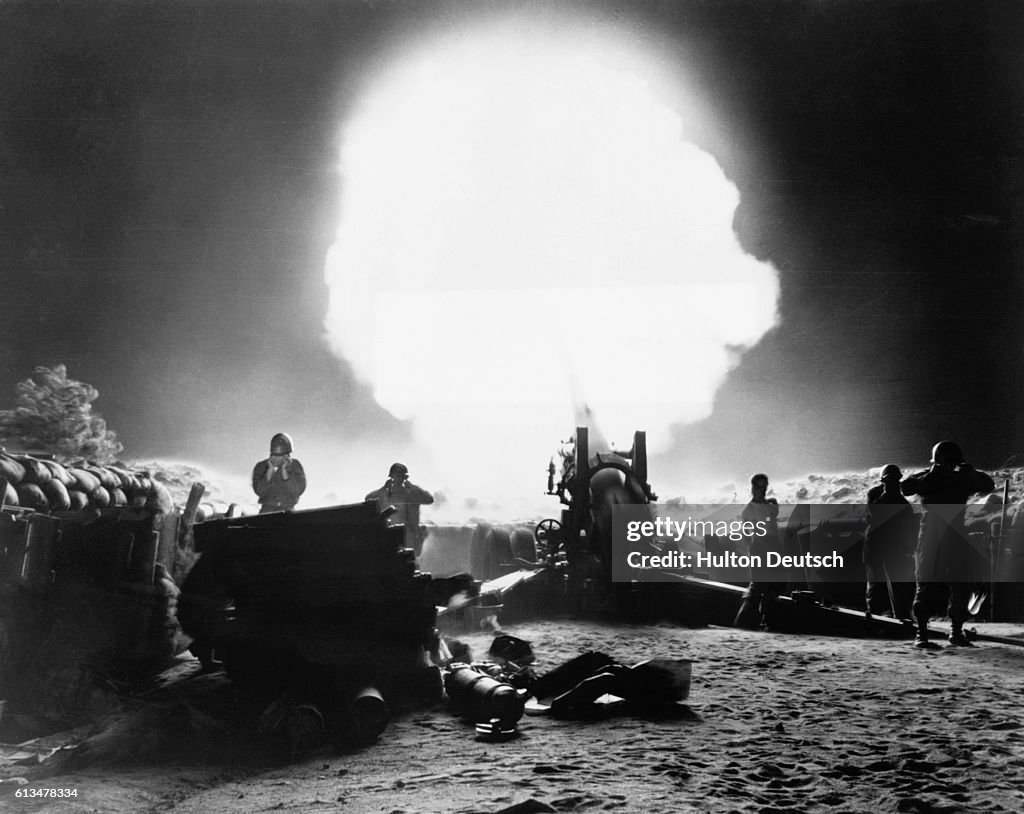 A shell fired by a 155 mm Howitzer explodes in the night sky,... News ...