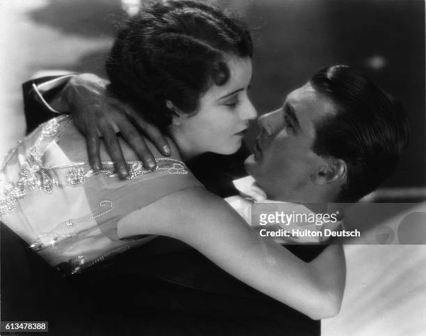 Actors Gary Cooper and Fay Wray embrace for kiss in one of their movies.