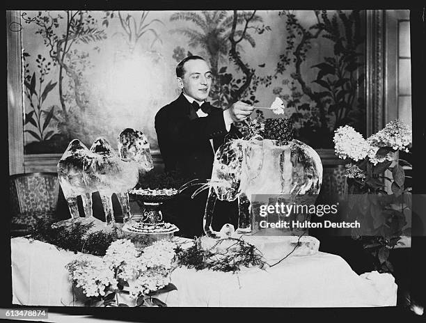 Waiter serves dessert from a table display featuring animals sculpted in ice, at a party given by the Maharajah of Patials, at London's Savoy Hotel.