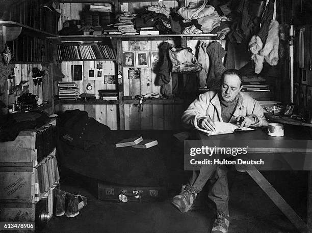 Captain Scott the Antarctic explorer writing in his journal in his expedition hut. He died on the return journey from the South Pole, but the journal...