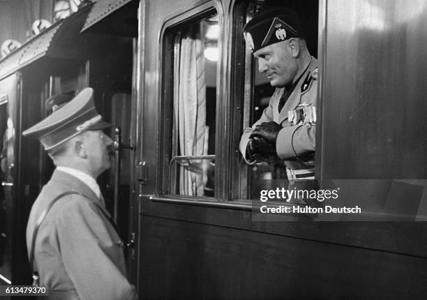 The Italian dictator Benito Mussolini is seen off in his armoured train from Berlin, by his German counterpart Adolf Hitler at the end of his 1937.