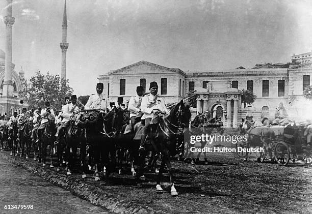 Turkish soldiers on horseback march down the streets of Constantinople to defend Libya, part of the Ottoman Empire, against the invading Italians in...