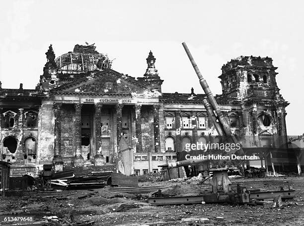 Lone abandoned artillery gun in front of the Reichstag building in Berlin.