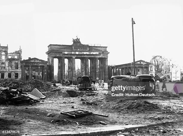Wrecked vehicles on Unter Den Linden with the Branderberger Tor in the background. Berlin 1945.