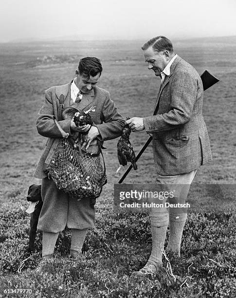 Colonel Frank Douglas checks the bag with gamekeeper James Petrie, during the lunch break at a grouse shoot on the Perthshire moors. | Location:...