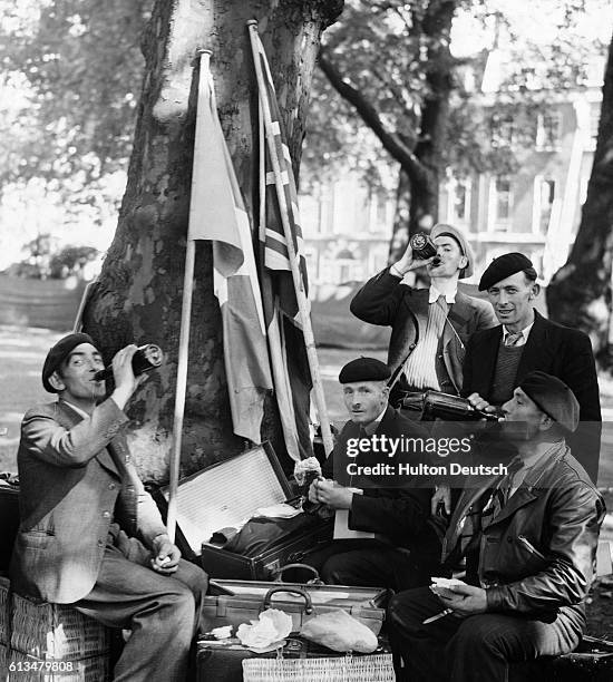 French reservists called up for registration at the French consulate enjoy lunch in Bedford Square while waiting to report, 1939.