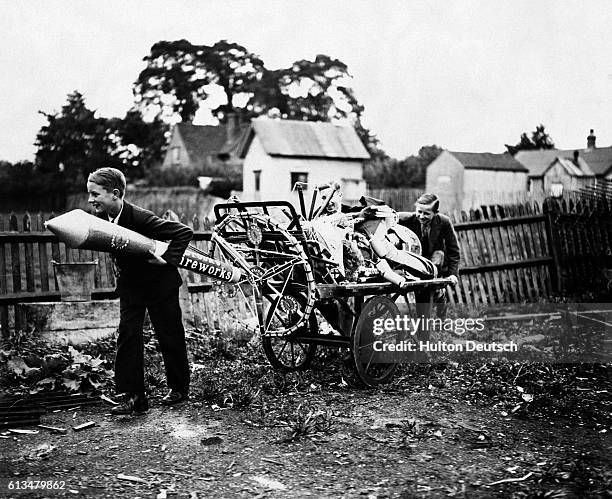 Boys push home a cart full of fireworks for a Guy Fawkes celebration.