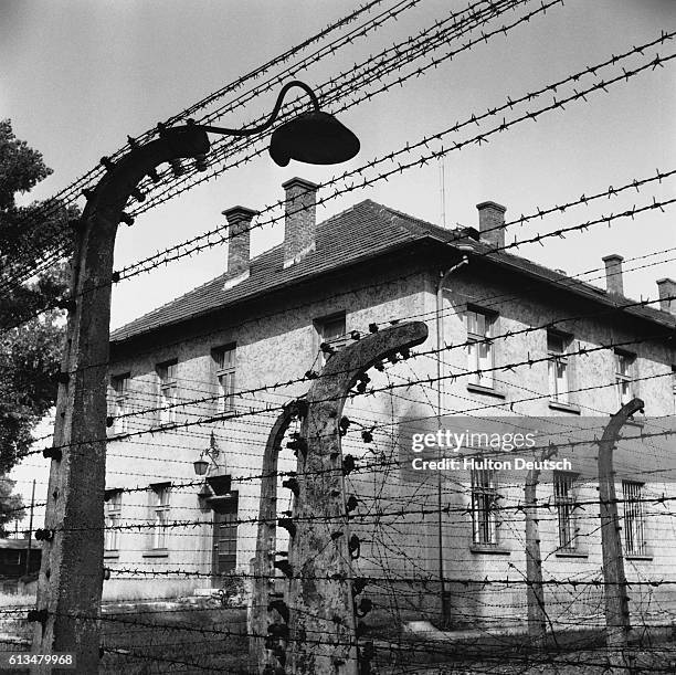 Rows of barbed wire line the fences at Auschwitz, one of Nazi Germany's most notorious concentration and extermination camps. The camp was abandoned...