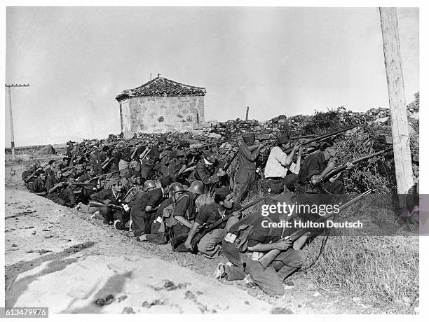 Nationalist fighters take shelter as they engage government forces, during the advance on Madrid.