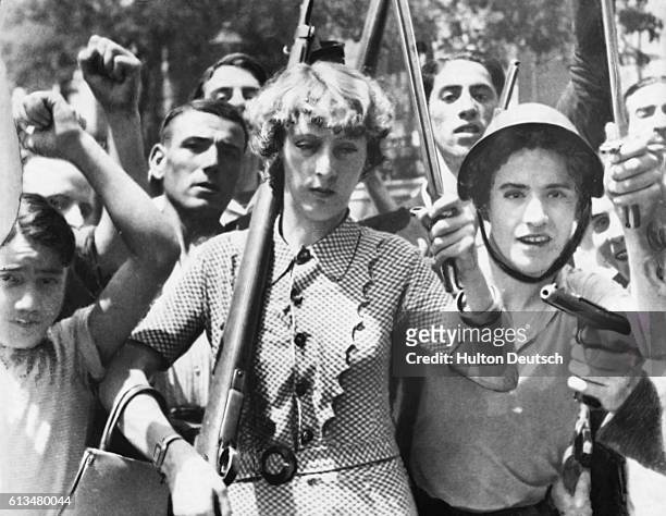 This group of Spanish workers armed by the government to fight against the rebels includes a woman carrying a rifle and bayonet. Madrid, Spain, ca....