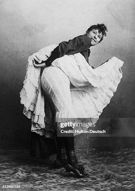 Cancan dancer lifts her skirt to reveal her bloomers.