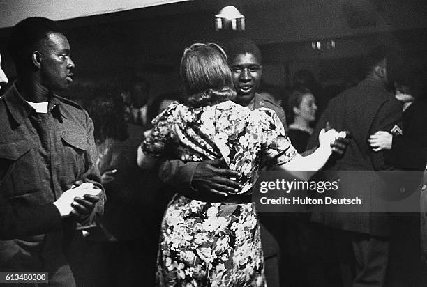 African-American soldiers and local girls dance to swing music at Bouillabaisse on New Compton Street, one of just a few London nightclubs that...