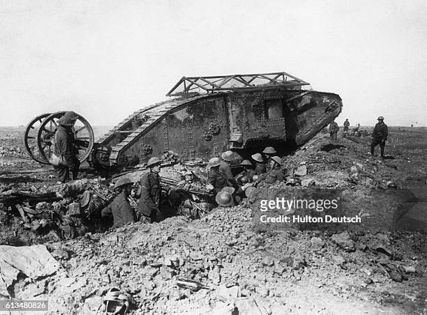 British tanks crossing a British trench during an attack, in 1917, on German positions in France.