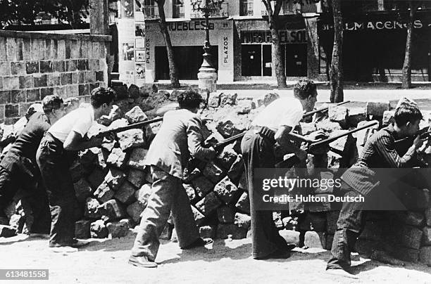 Armed civilians guard a barricade during the Spanish Civil War . | Location: Barcelona, Spain.