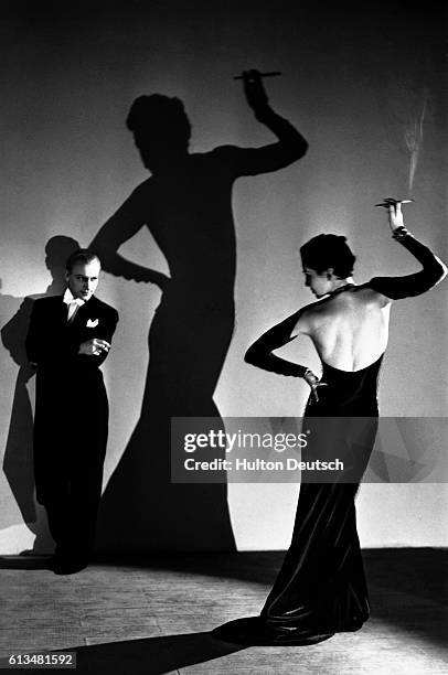 Cabaret dancer Lisa makes a shadow on the wall during a performance with Wos Adams.