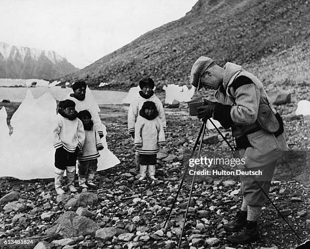 Tourist Warner Hall photographs Inuit parents, and their children, employed at the Craig Harbour Detachment of the Royal Canadian Mounted Police. |...