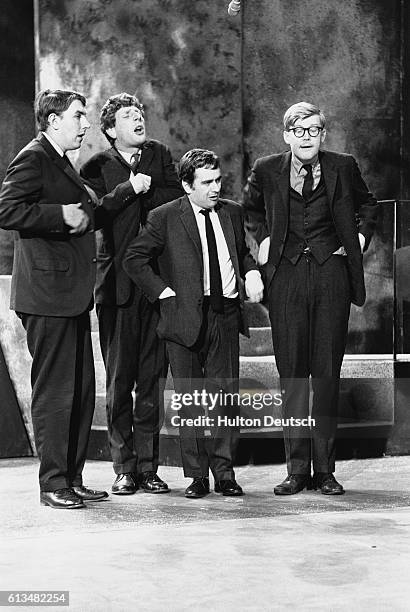 Jonathan Miller, Peter Cook, Dudley Moore, and Alan Bennett in a sketch from their revue show Beyond the Fringe.