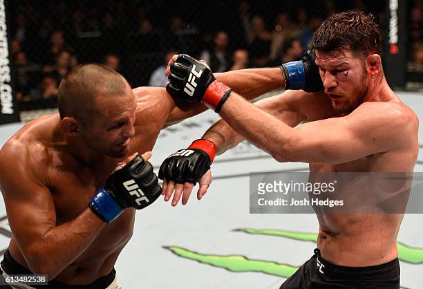 Dan Henderson punches Michael Bisping of England in their UFC middleweight championship bout during the UFC 204 Fight Night at the Manchester Evening...